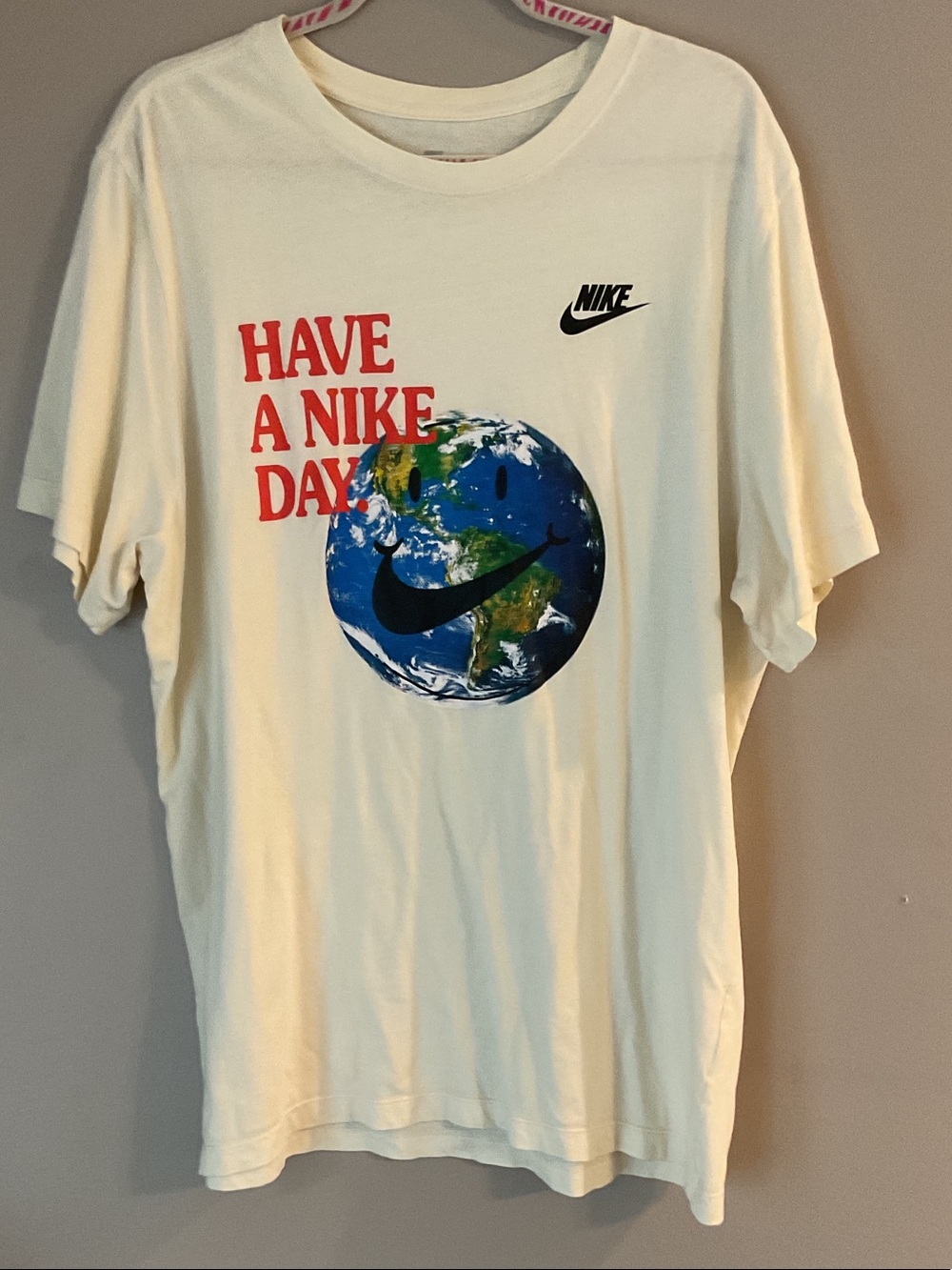 Nike Cream Graphic Tee with Red Text & Blue/Green Earth